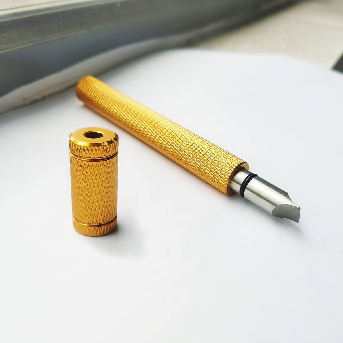 Gold golf groove sharpener with textured grip and metal tip