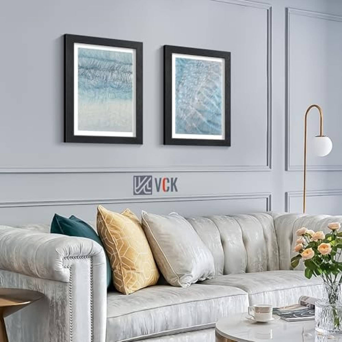 Set of black wood picture frames on wall with blue artwork
