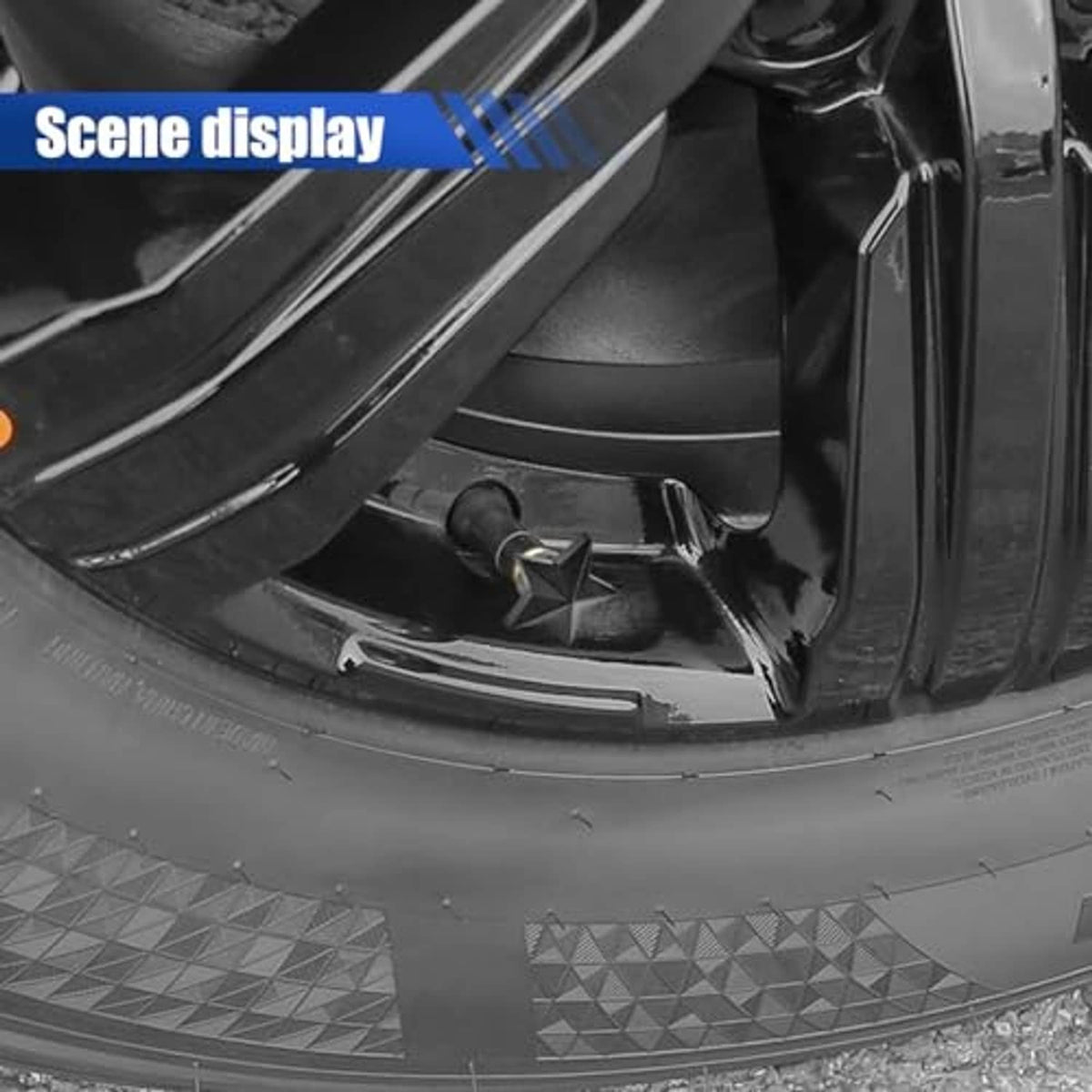 Black five-point star tire valve stem cap on a wheel valve stem