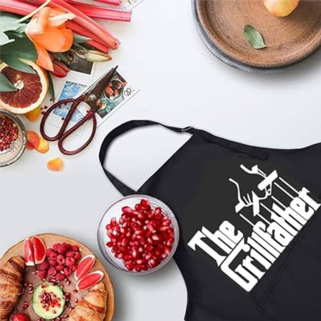 Black apron with 'The Grillfather' print, laid flat