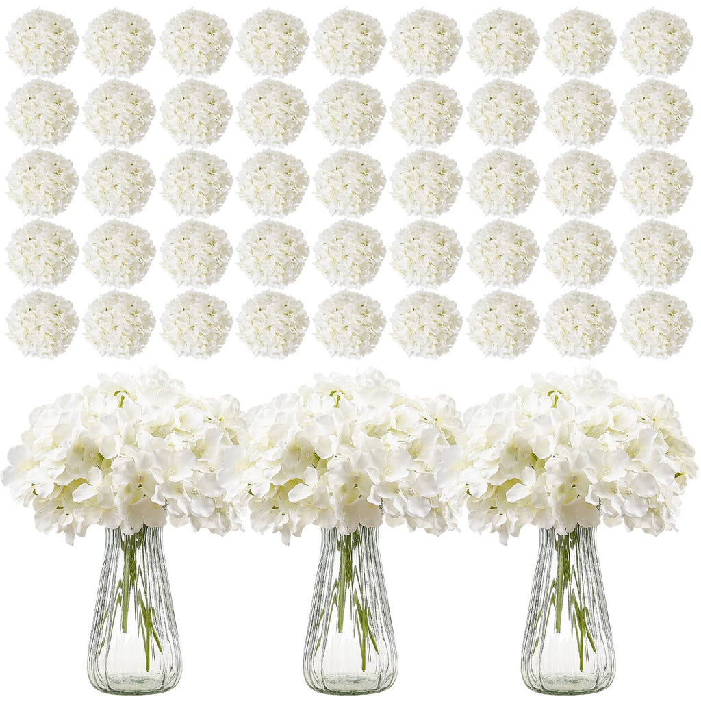 Artificial white hydrangea bouquet arrangement with three small vases and gathered blooms