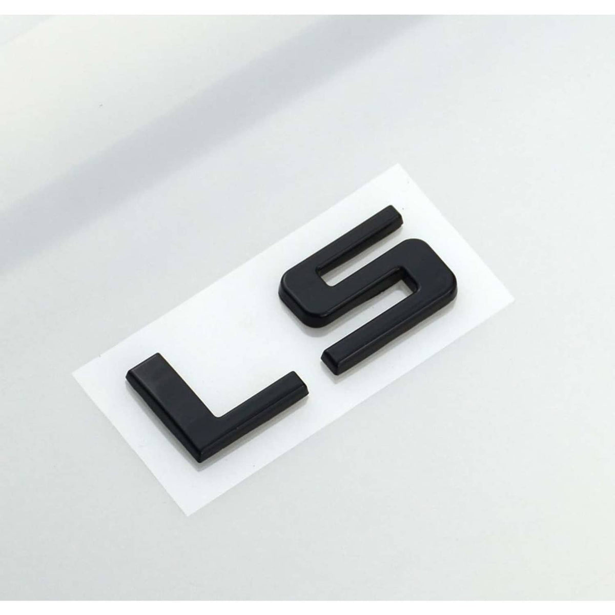 Gloss black LS emblem badge pair, two raised letters on white backing.