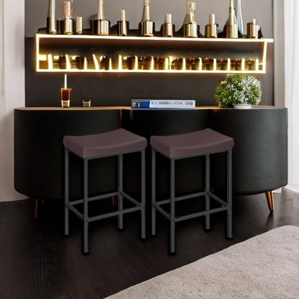 Two bar stools with dark brown cushioned seats and black frames under a bar.