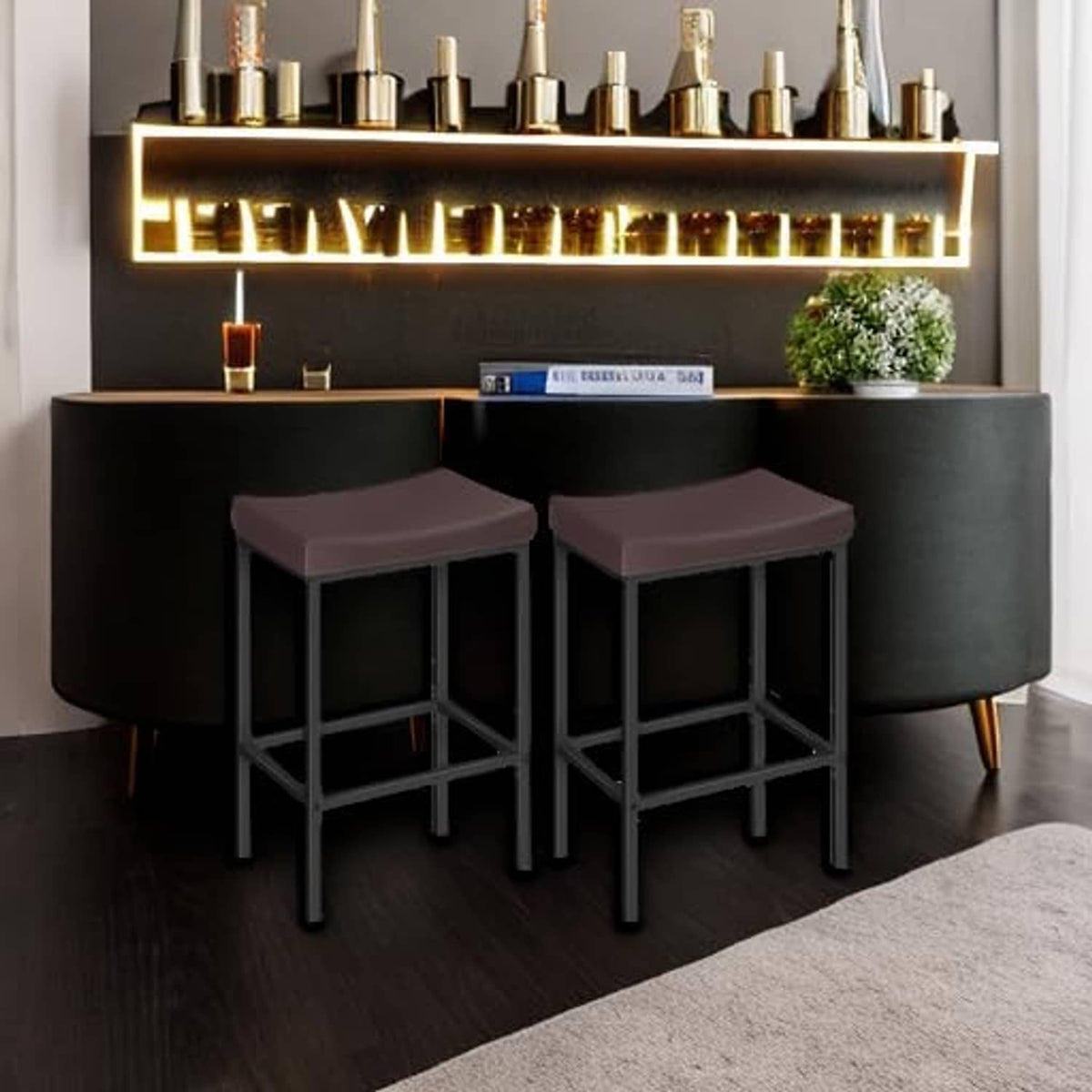 Two bar stools with dark brown cushioned seats and black frames under a bar.