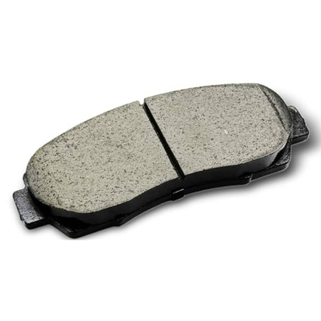 Ceramic brake pad with gray friction face and black metal backing, angled close-up