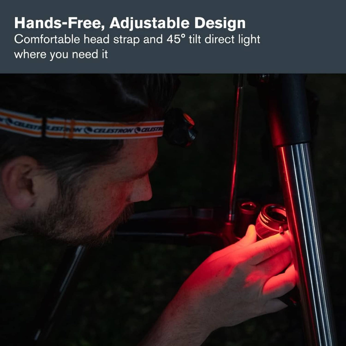 Night vision headlamp being adjusted with black body and orange headband
