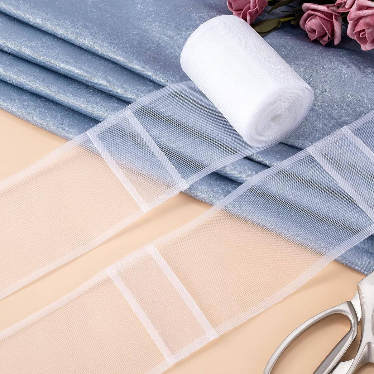 White translucent pleating tape laid flat, showing sheer mesh and cut-ready strip