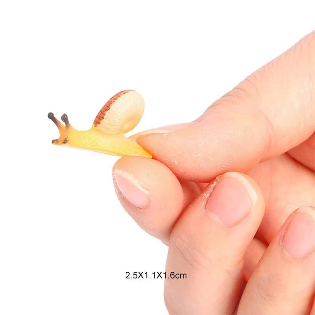 Realistic mini snail figurine held in a hand, small pale yellow shell with brown antennae.