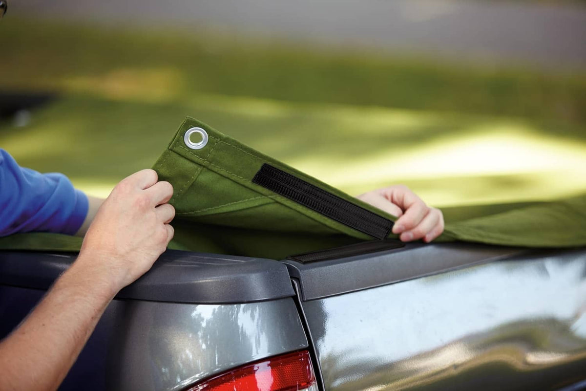 Black interlocking fastener strip securing a tarp or cover