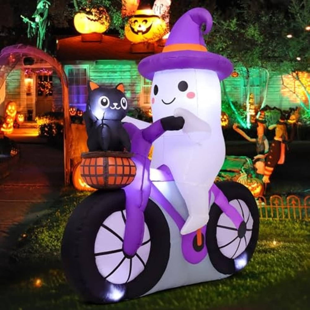 Inflatable Halloween ghost on bicycle with purple glow, smiling face, and cat in basket
