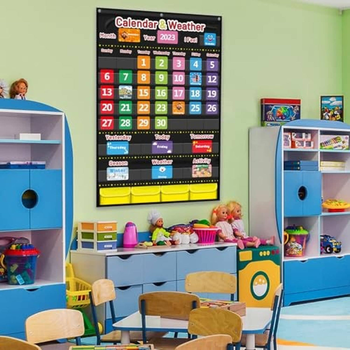 Kids classroom wall with a black calendar & weather pocket chart and date pockets
