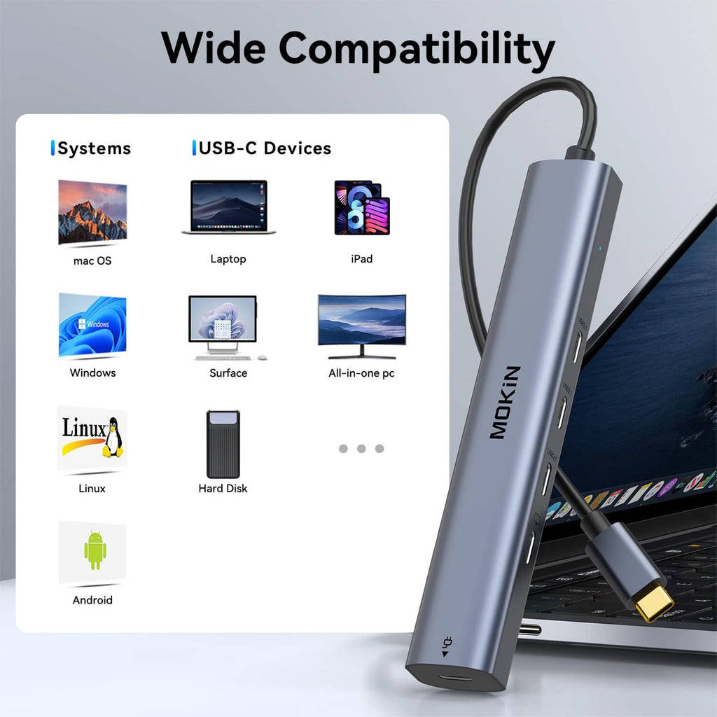 Metallic gray USB-C hub with a USB-C cable inserted and side ports visible