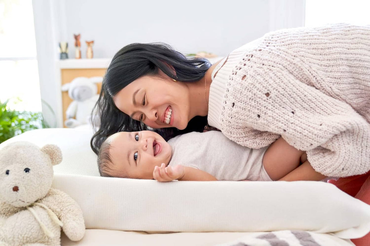 Diaper rash cream for sensitive baby, shown with cuddling mother and newborn