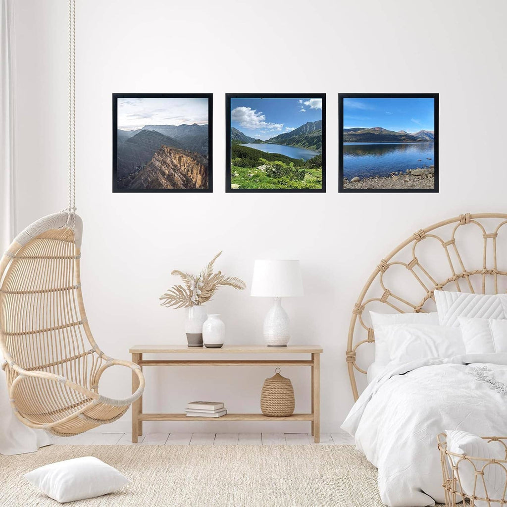 Black photo frame showing a landscape mountain scene, wall-mounted