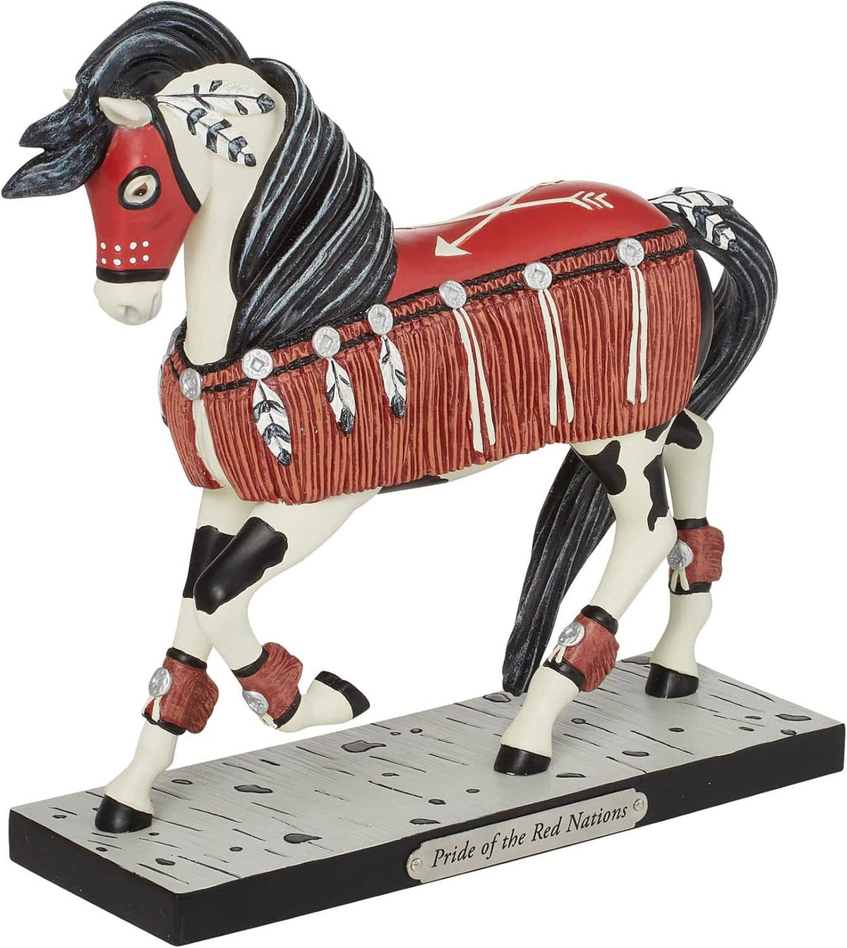 Painted horse figurine in side view, black-and-white legs, red saddle with fringe, on base