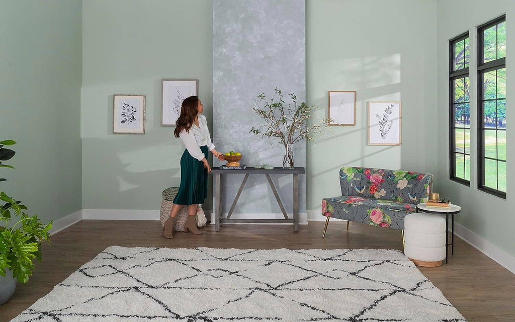 Gray concrete-textured accent wall in a bright interior room