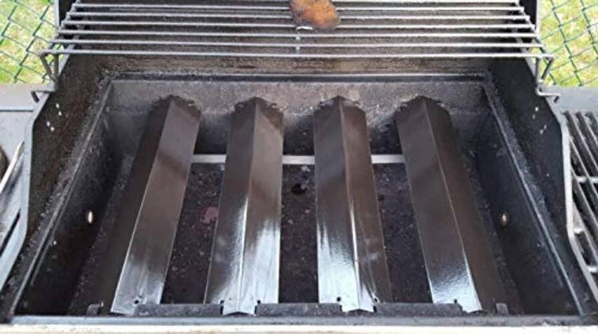 Installed black grill heat deflector bars inside open grill firebox