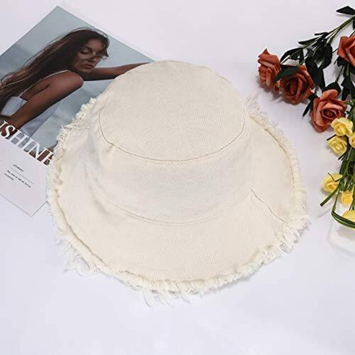 Cream wide-brim cotton bucket hat with stitched crown and frayed brim edge