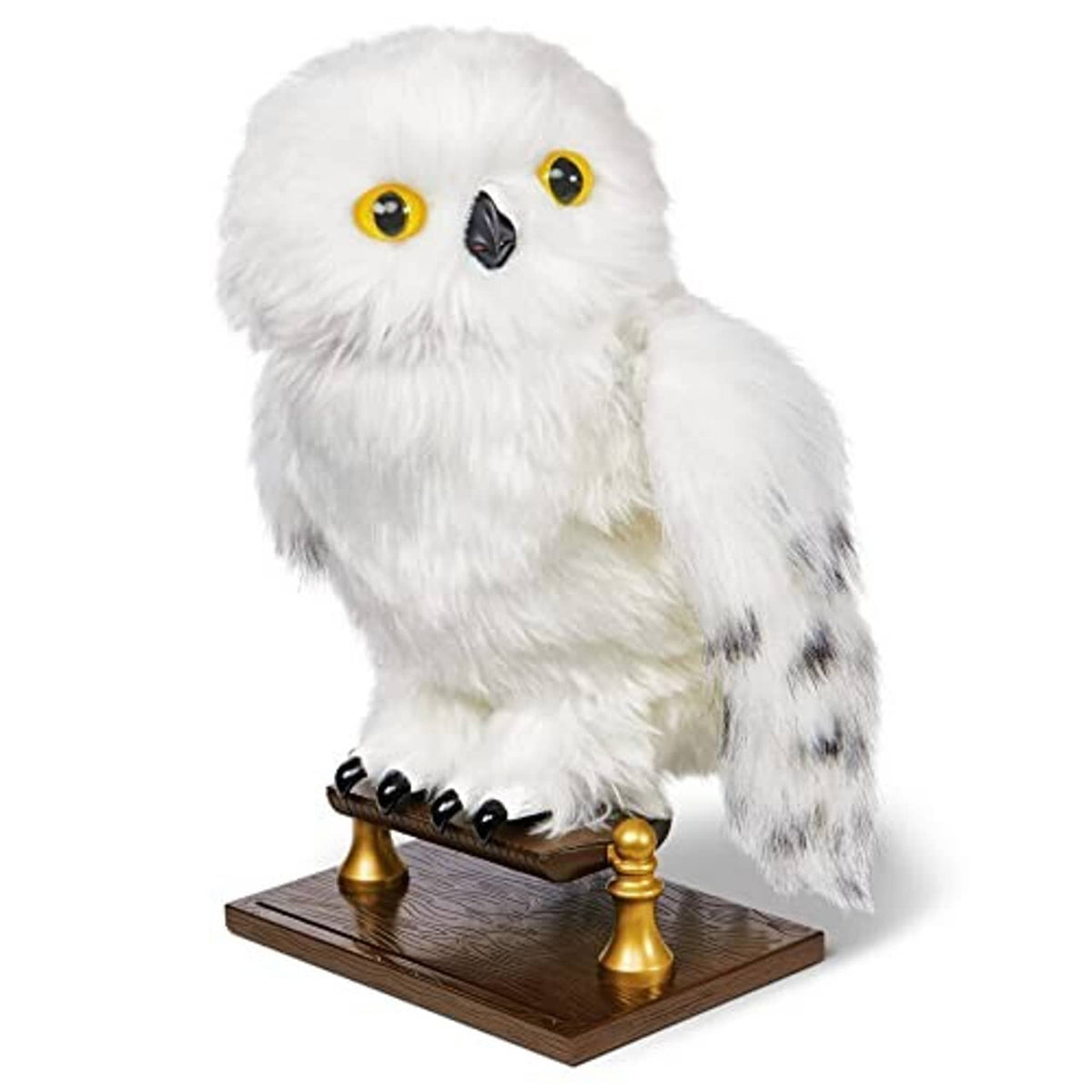 White fluffy owl plush on a dark brown stand with gold posts and amber eyes.