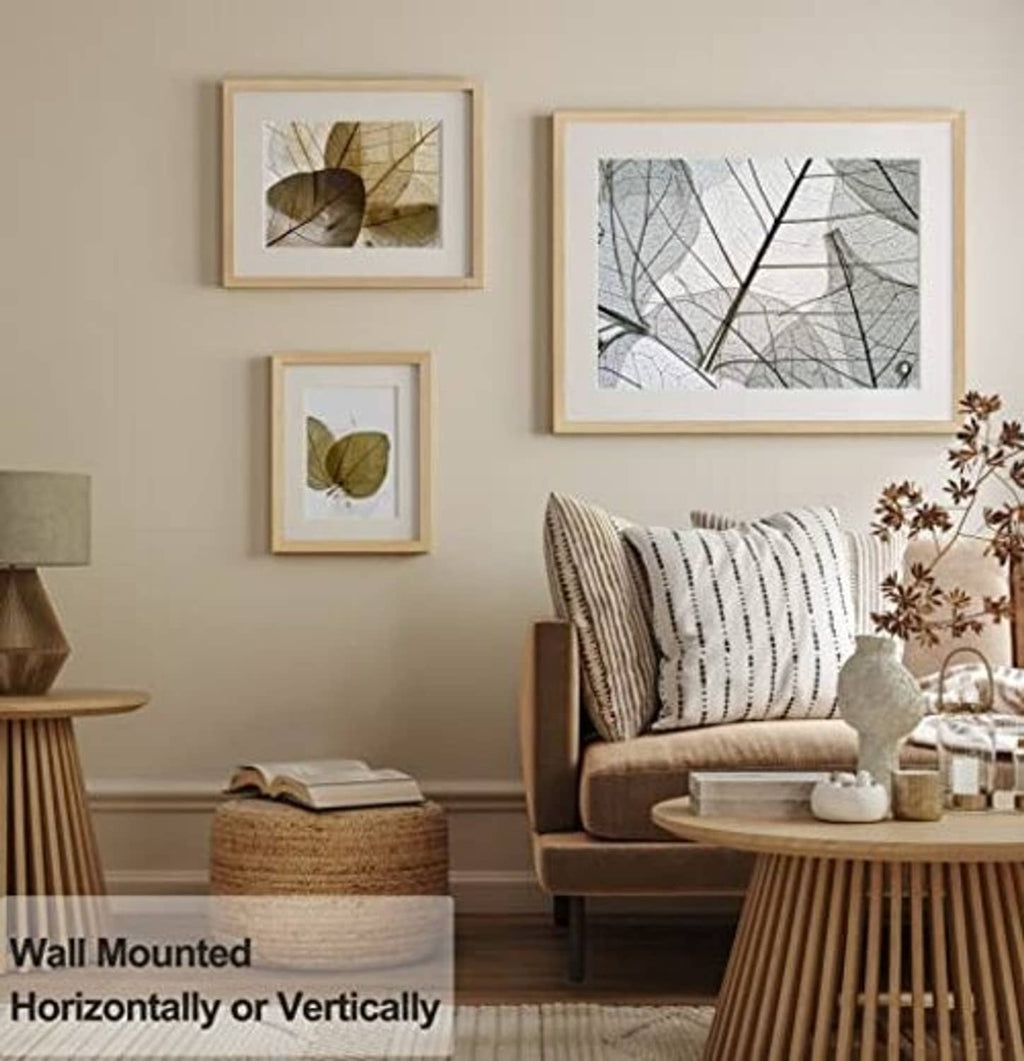 Two wall-mounted light oak picture frames with white mats and nature prints