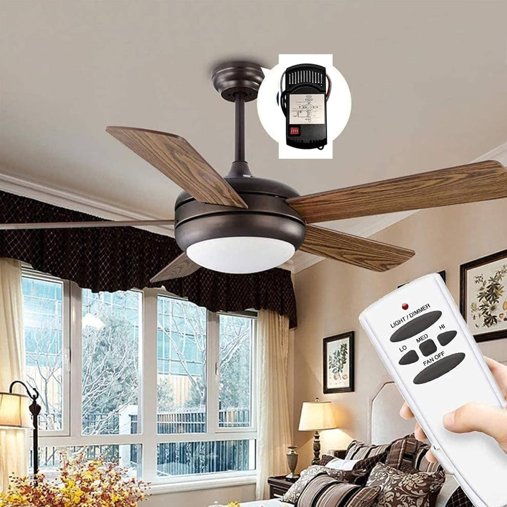 Ceiling fan remote control being held near a ceiling fan with light kit
