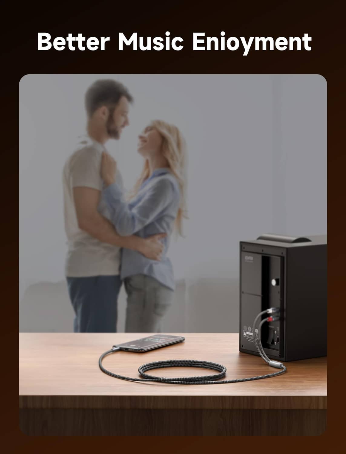 Braided 3.5mm to RCA audio cable connected to a speaker for music playback