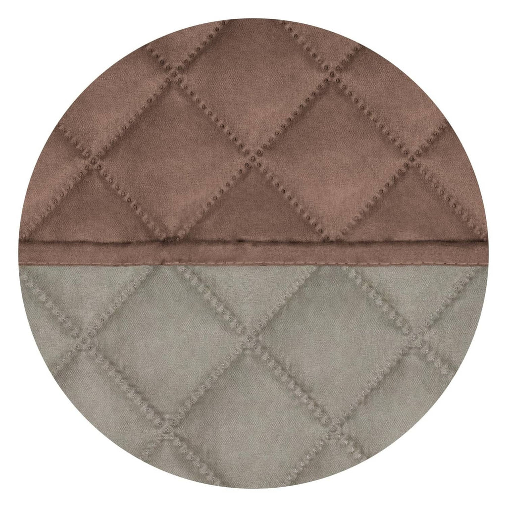 Reversible quilted sofa cover close-up showing brown top and light beige inner layer