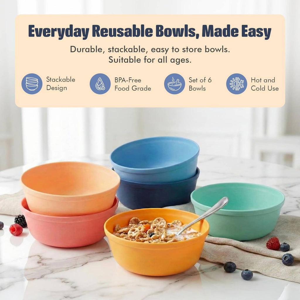 Set of deep plastic bowls with serving spoon in orange, blue, teal, and coral.