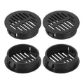 Round black plastic soffit vent covers with slotted grille openings (4 shown)