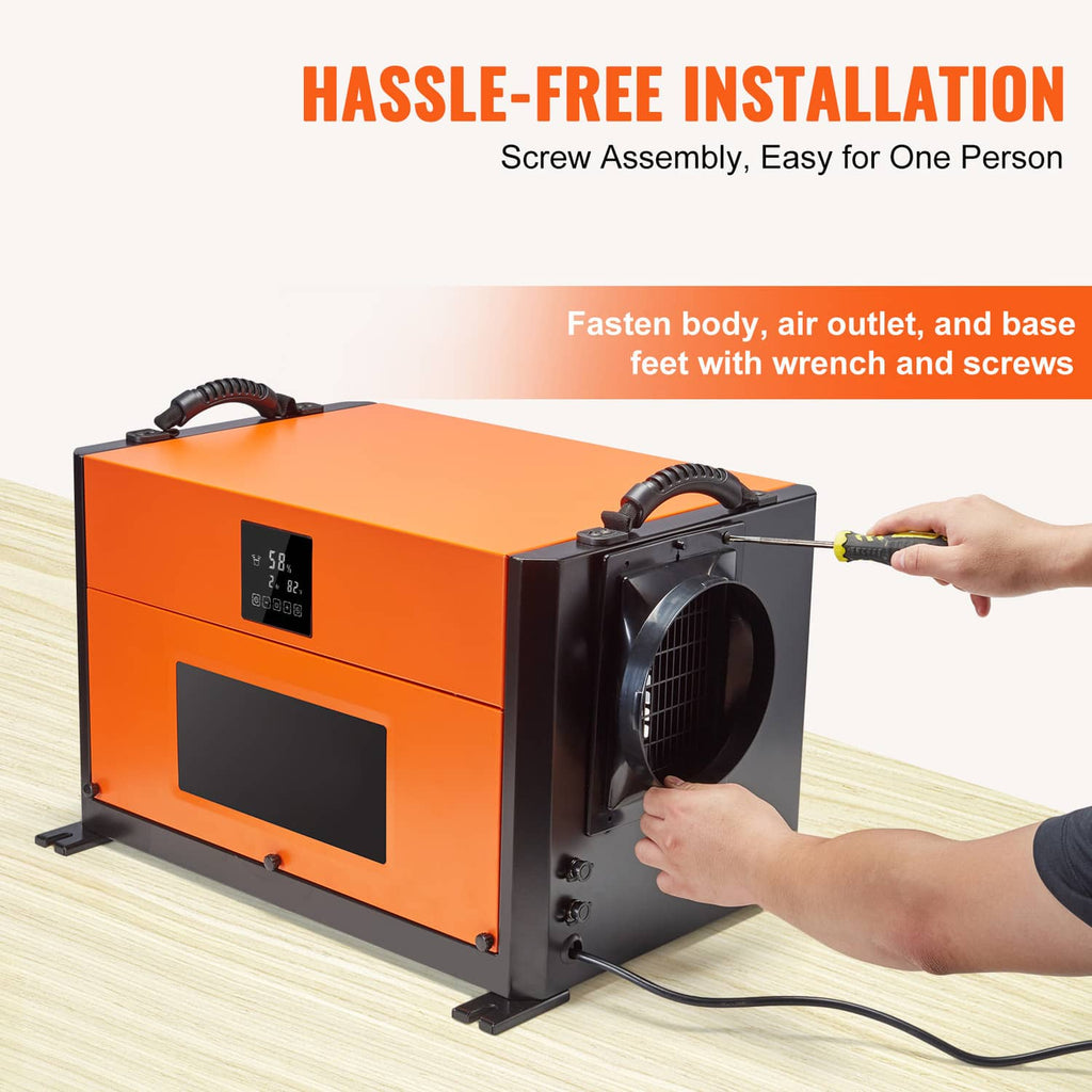 Commercial dehumidifier with orange body, side fan outlet, and hand-installed power cord.