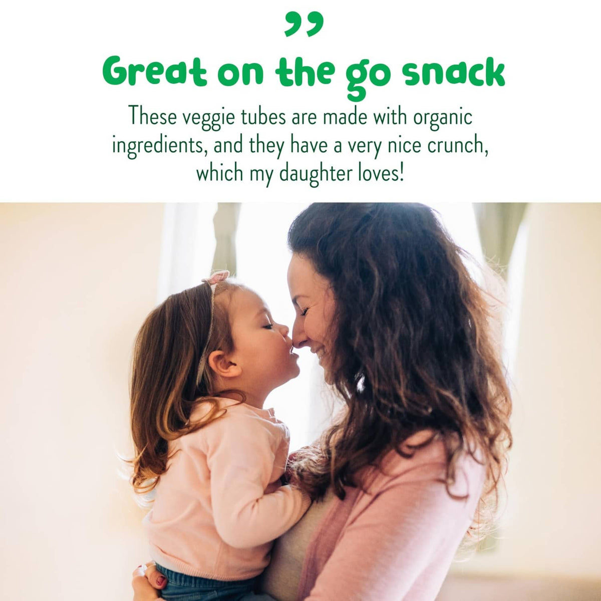 Parent and toddler smiling, snack time for veggie tubes