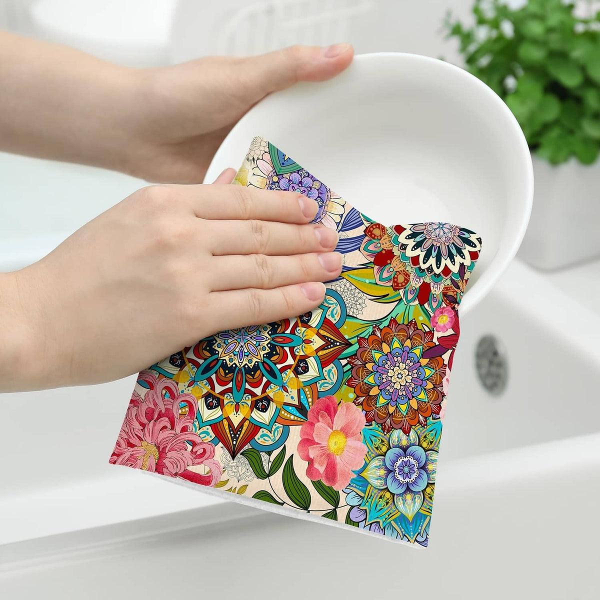 Boho floral kitchen towel held over sink, vibrant multicolor flower pattern
