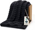 Black plush throw blanket with chunky ribbed texture and folded edge
