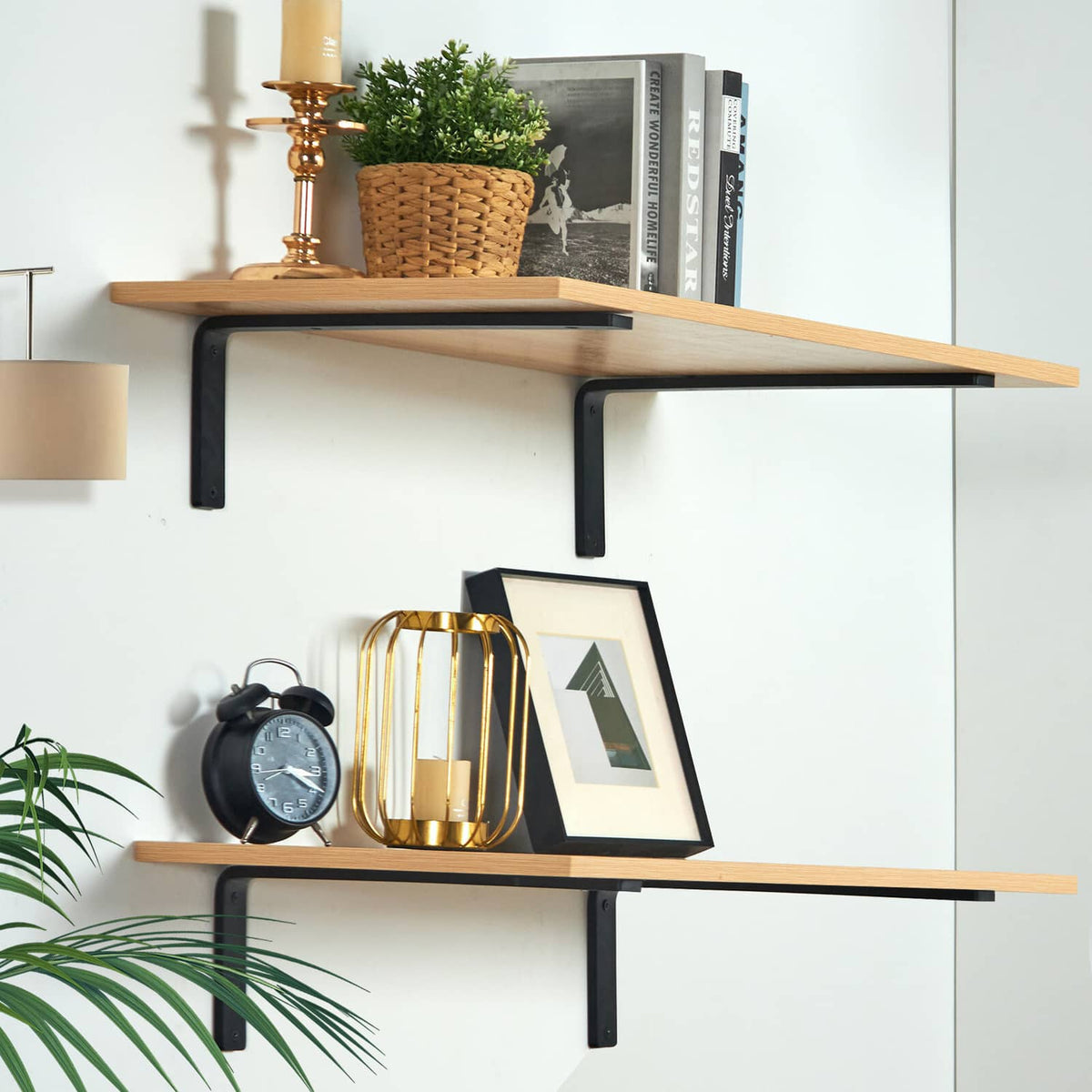 Two-tier wall shelf arrangement with black L-shaped brackets supporting wooden shelves