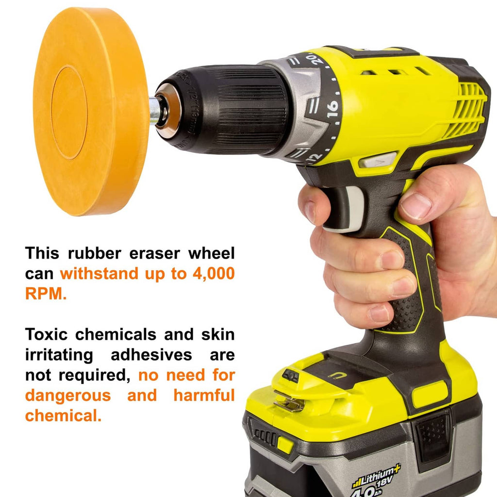 Yellow rubber eraser wheel attached to a handheld drill tool, held in a hand