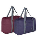 Foldable personal item duffel bag set in burgundy and navy with gray carry straps