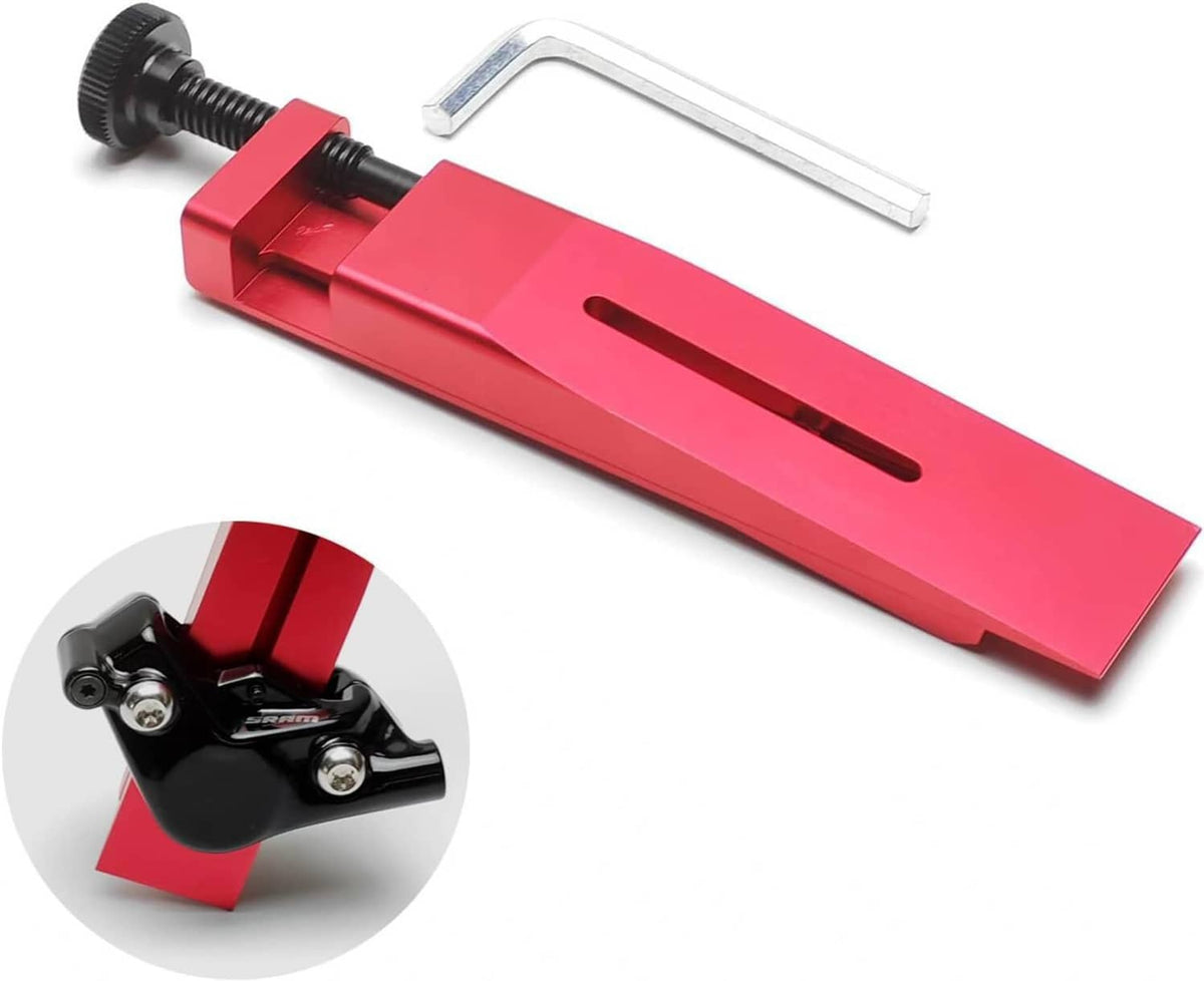 Red bicycle brake caliper piston press tool with hex key and clamp screw