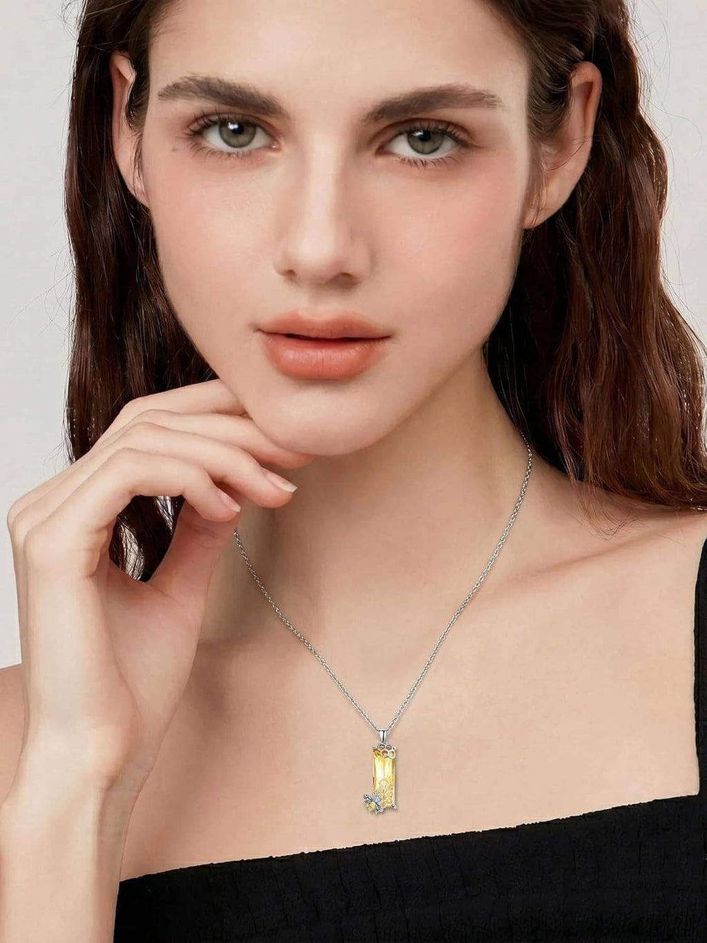 Silver chain necklace with small rectangular honeycomb crystal pendant on model