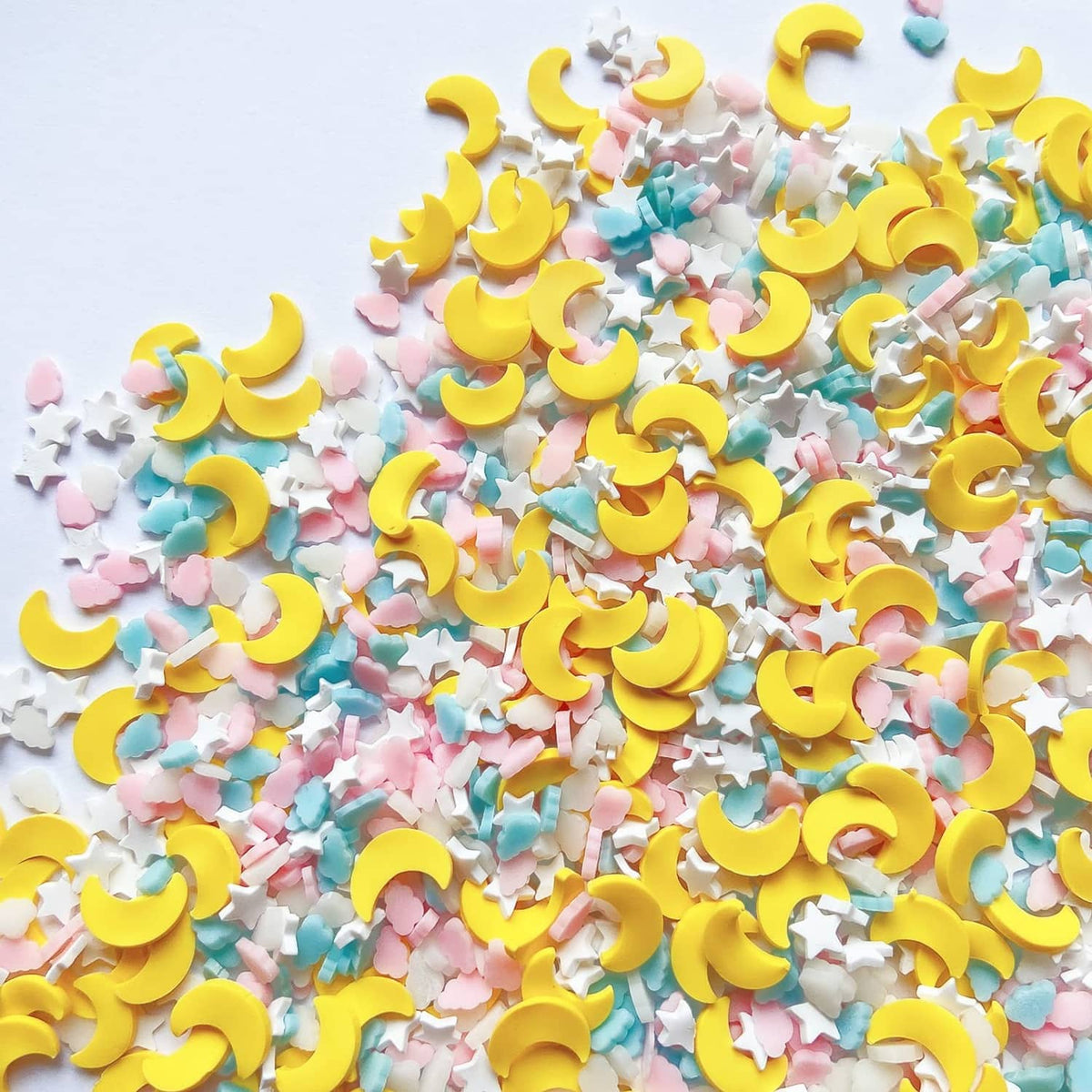 Moon and cloud confetti sprinkles with yellow moons, pastel pieces, and white stars