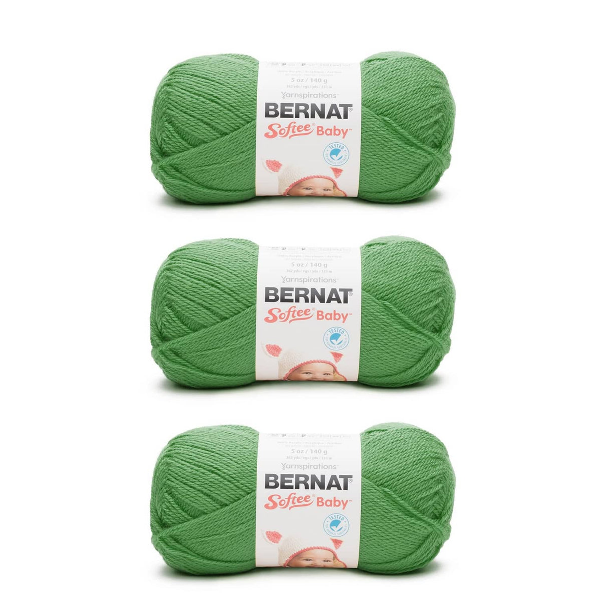 Three grass green Bernat Softee Baby yarn skeins with labels, DK weight acrylic