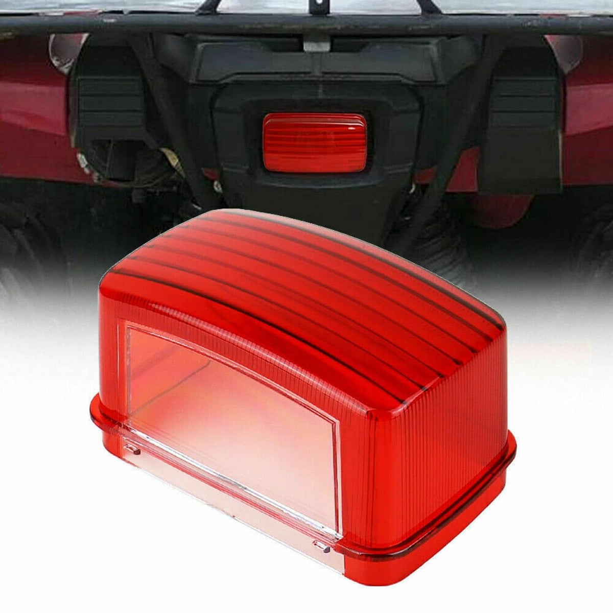Red tail light lens mounted on ATV rear, ribbed red cover with clear window