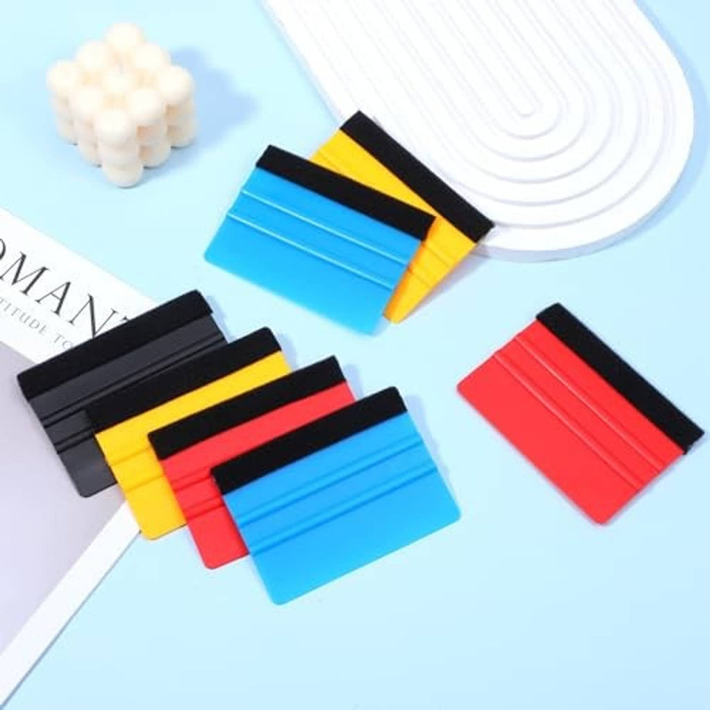 Set of felt-edge squeegees in blue, red, yellow, and black with grip ridges.