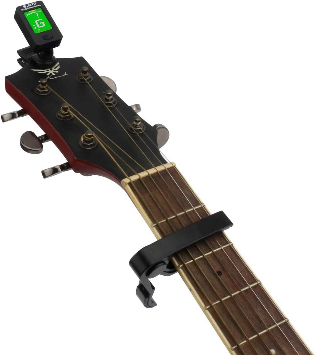 Clip-on tuner capo attached to guitar headstock, LCD shows G note