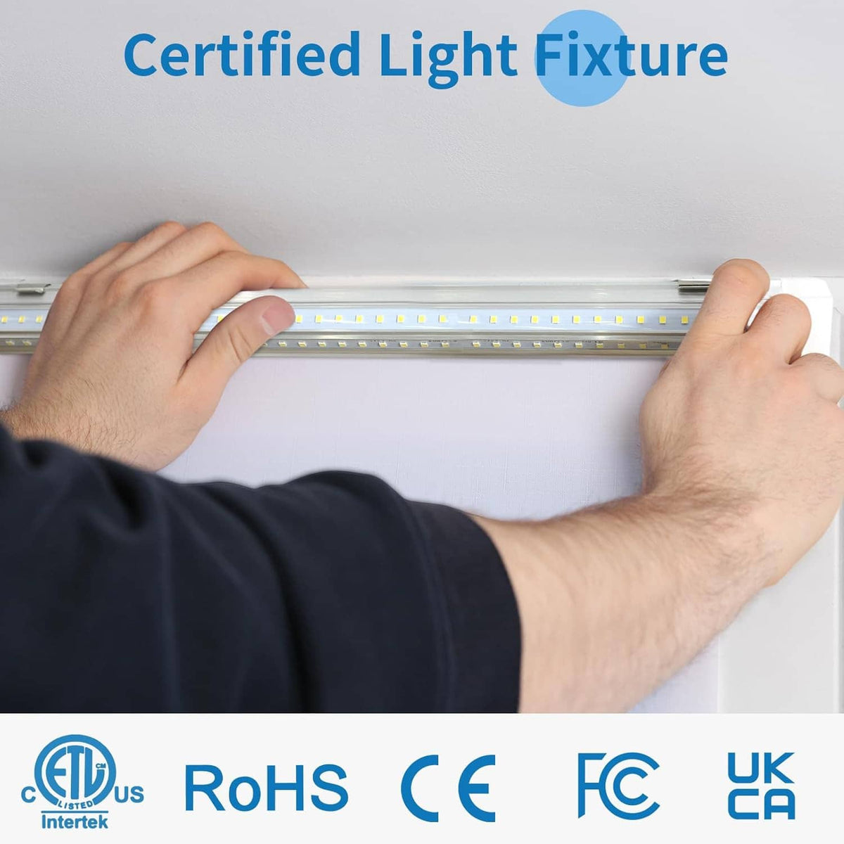 LED shop light fixture being installed into ceiling clips, white housing
