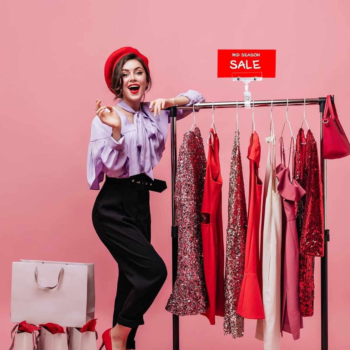 Clear sign holder clips on clothing rack holding sale and price tags on garments