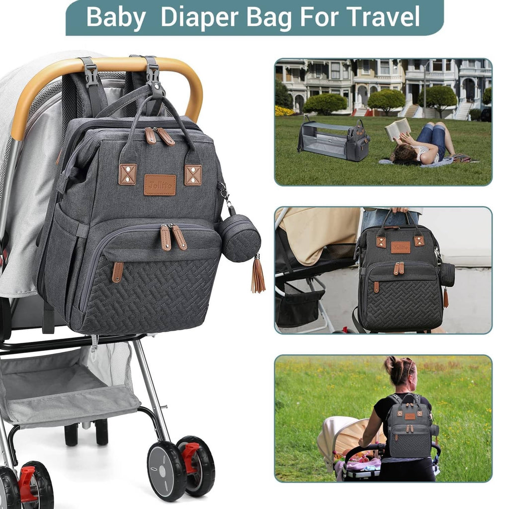 Grey diaper bag backpack with changing station, shown on a stroller