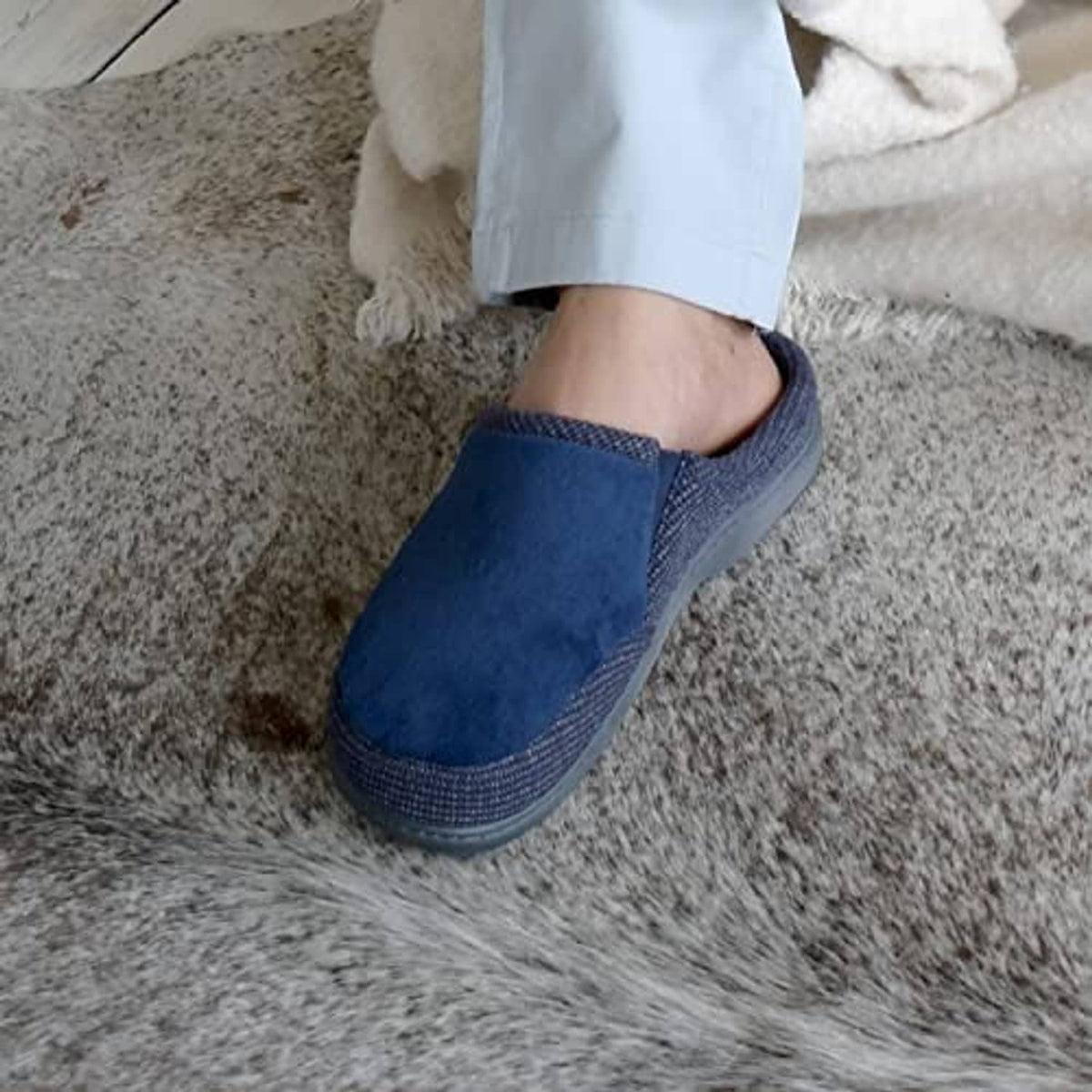 Men's navy slip-on slipper worn with pant cuff