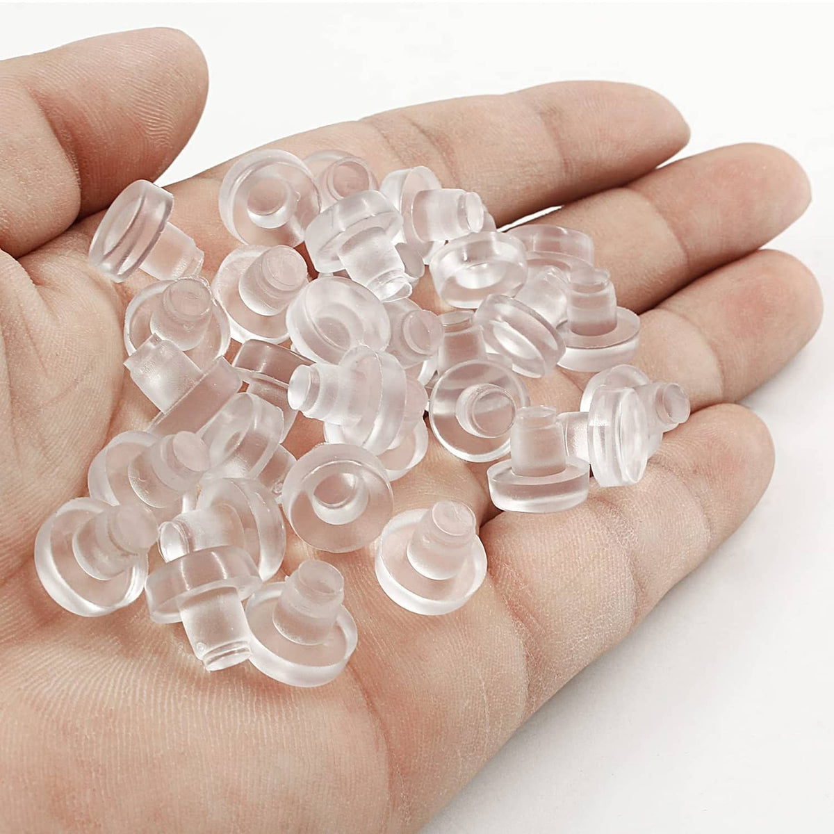 Clear table top bumper pieces with stems in a hand