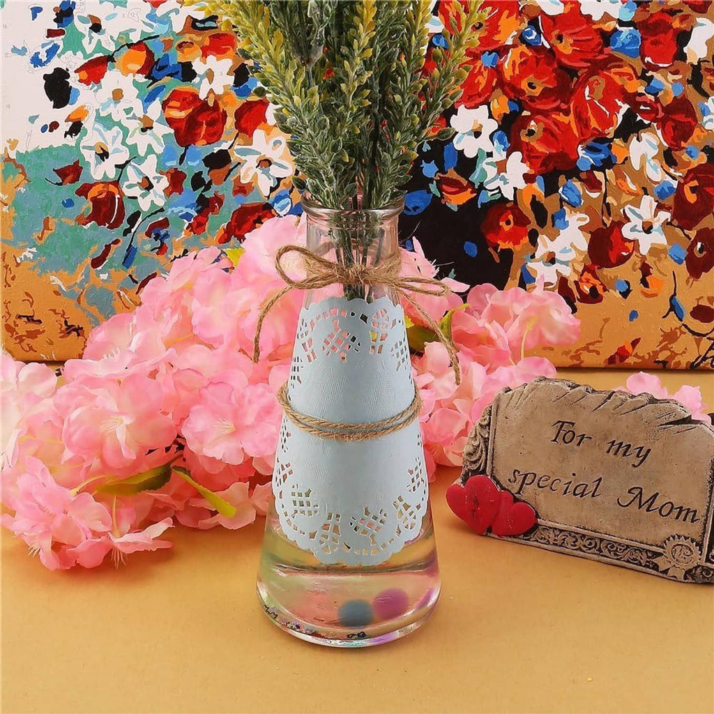Round light blue paper lace doily with scalloped edge and cutout lattice pattern