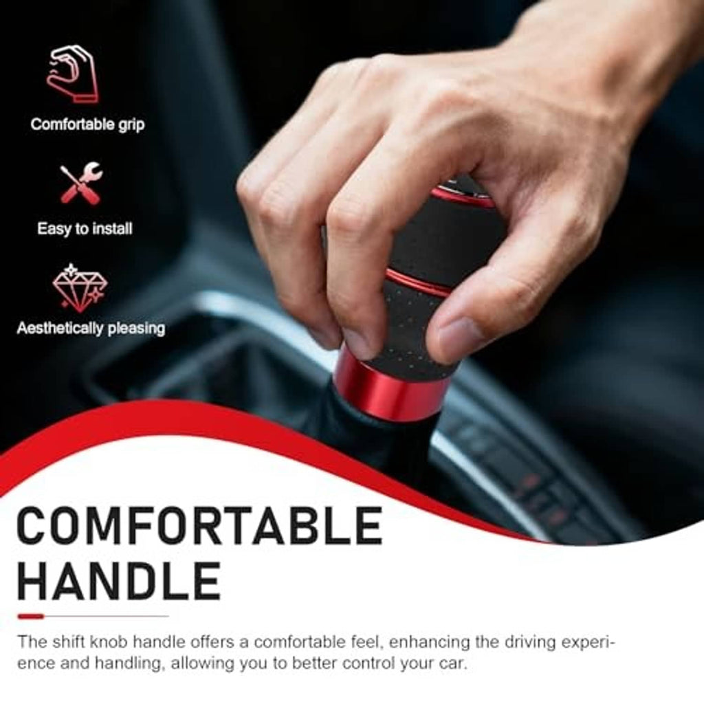Black leather gear shift knob with red ring, held by hand for grip